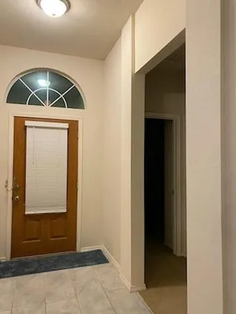 a view of a chandelier in big room and chandelier