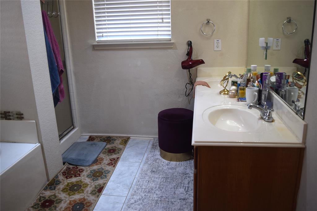 1714 Rustic Lane Garland, TX 75040 - Photo 7 of 20 a bathroom with a sink and a mirror
