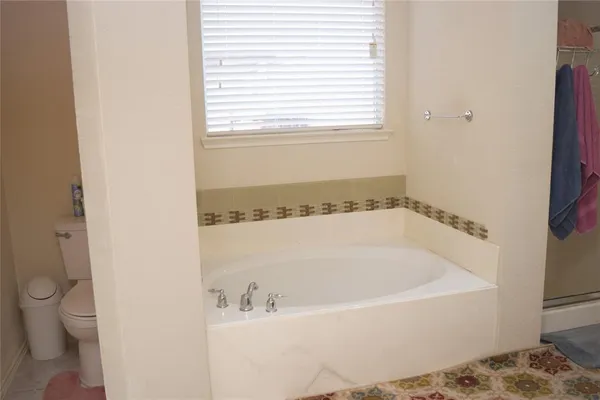 a white bath tub sitting next to a white toilet