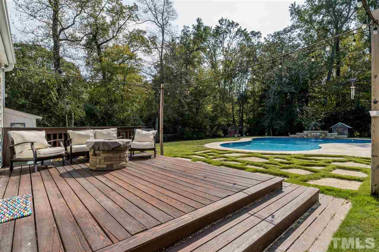 800 Hardimont Road Raleigh, NC 27609 - Photo 20 of 26 a view of a wooden deck with chairs and large trees