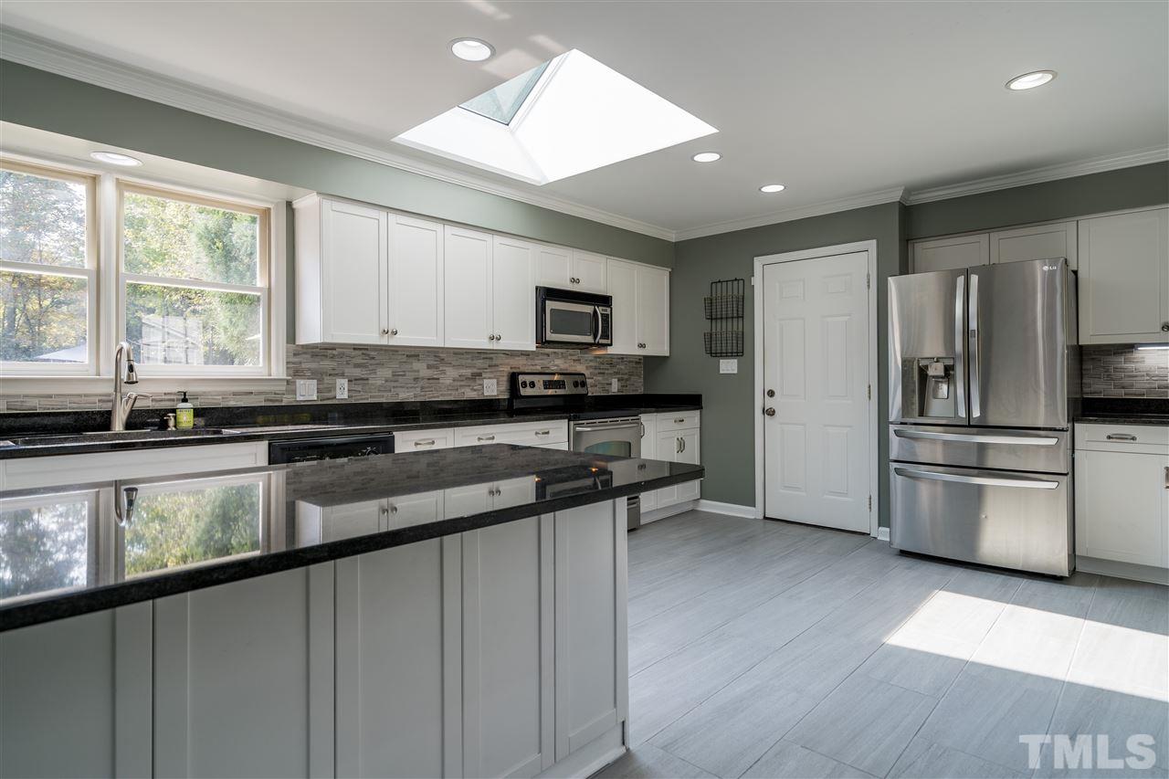 800 Hardimont Road Raleigh, NC 27609 - Photo 3 of 26 a kitchen with granite countertop a refrigerator and a sink