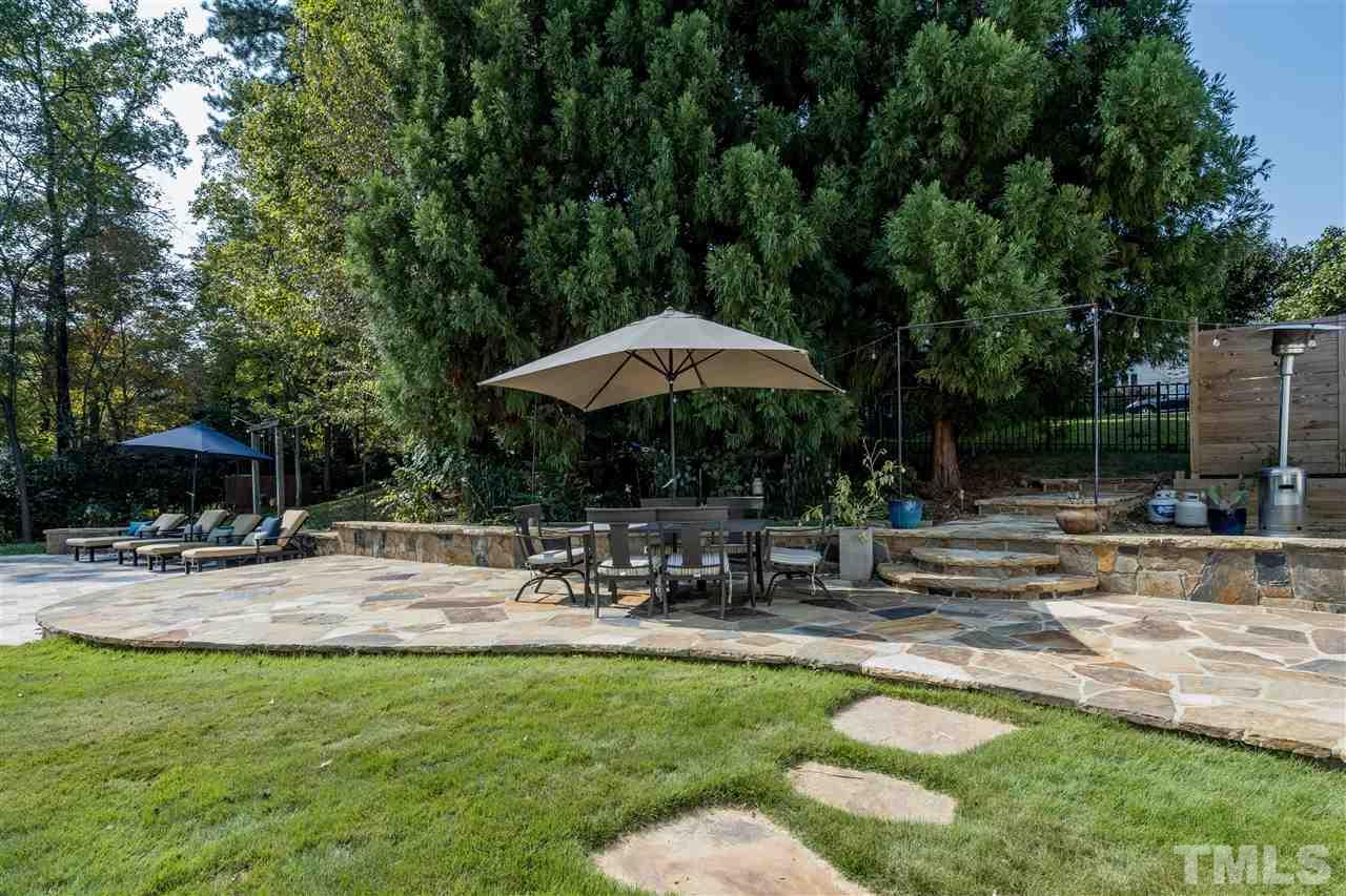 800 Hardimont Road Raleigh, NC 27609 - Photo 21 of 26 a view of patio with chairs and table under an umbrella