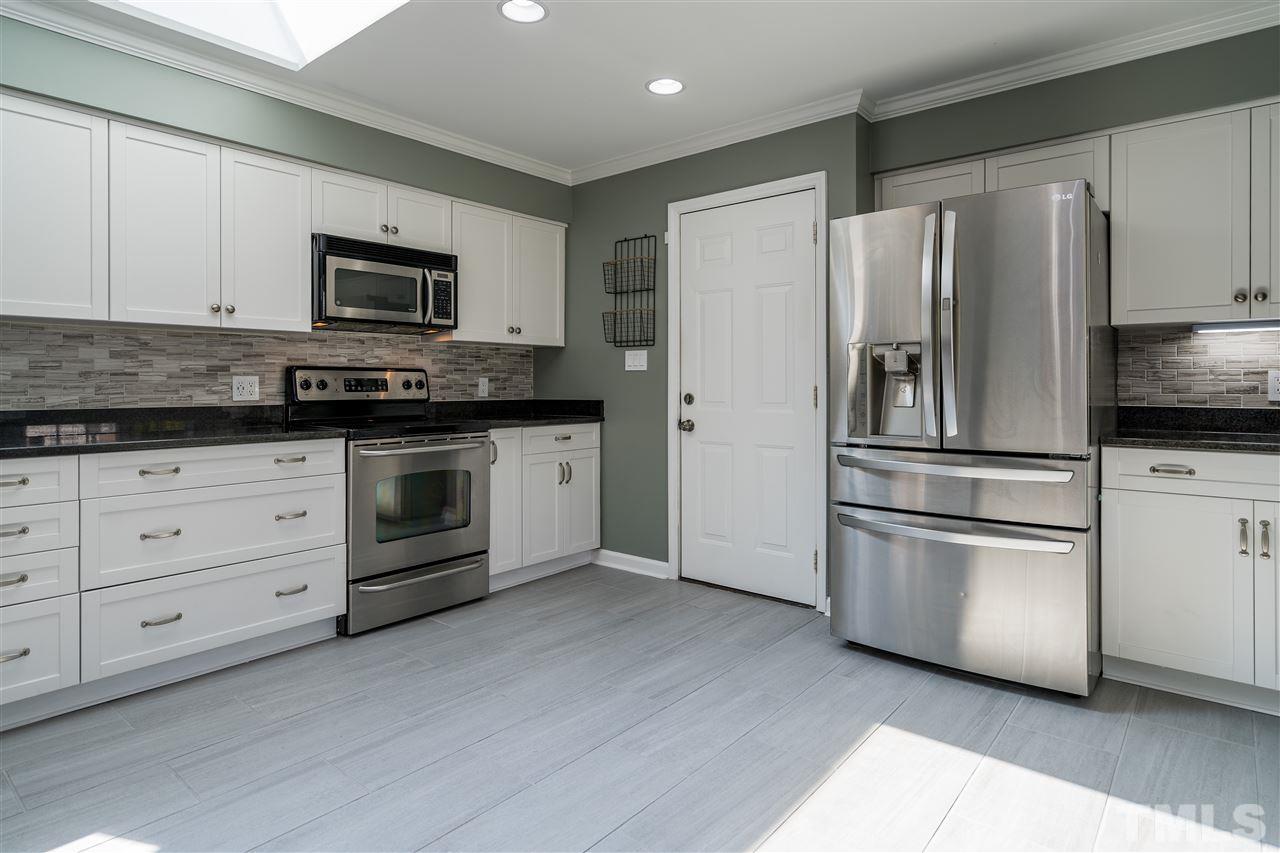 800 Hardimont Road Raleigh, NC 27609 - Photo 4 of 26 a kitchen with stainless steel appliances granite countertop a refrigerator stove and white cabinets