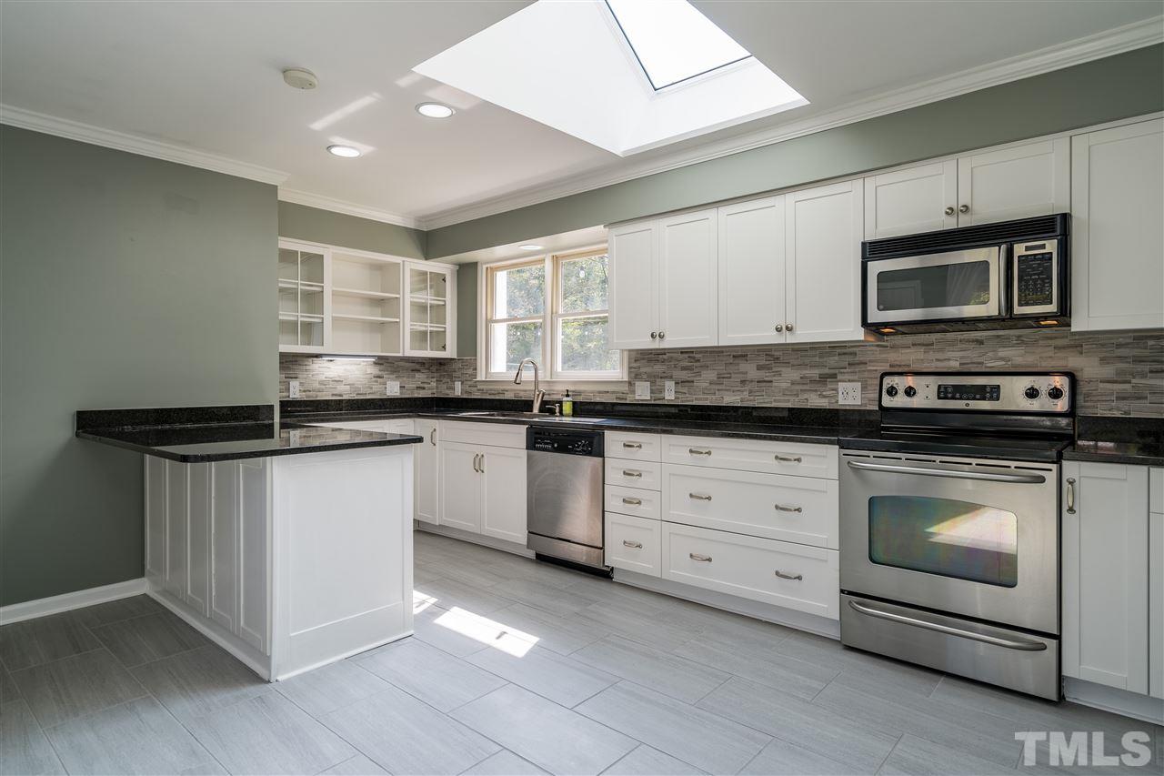 800 Hardimont Road Raleigh, NC 27609 - Photo 5 of 26 a kitchen with granite countertop white cabinets white stainless steel appliances and a sink