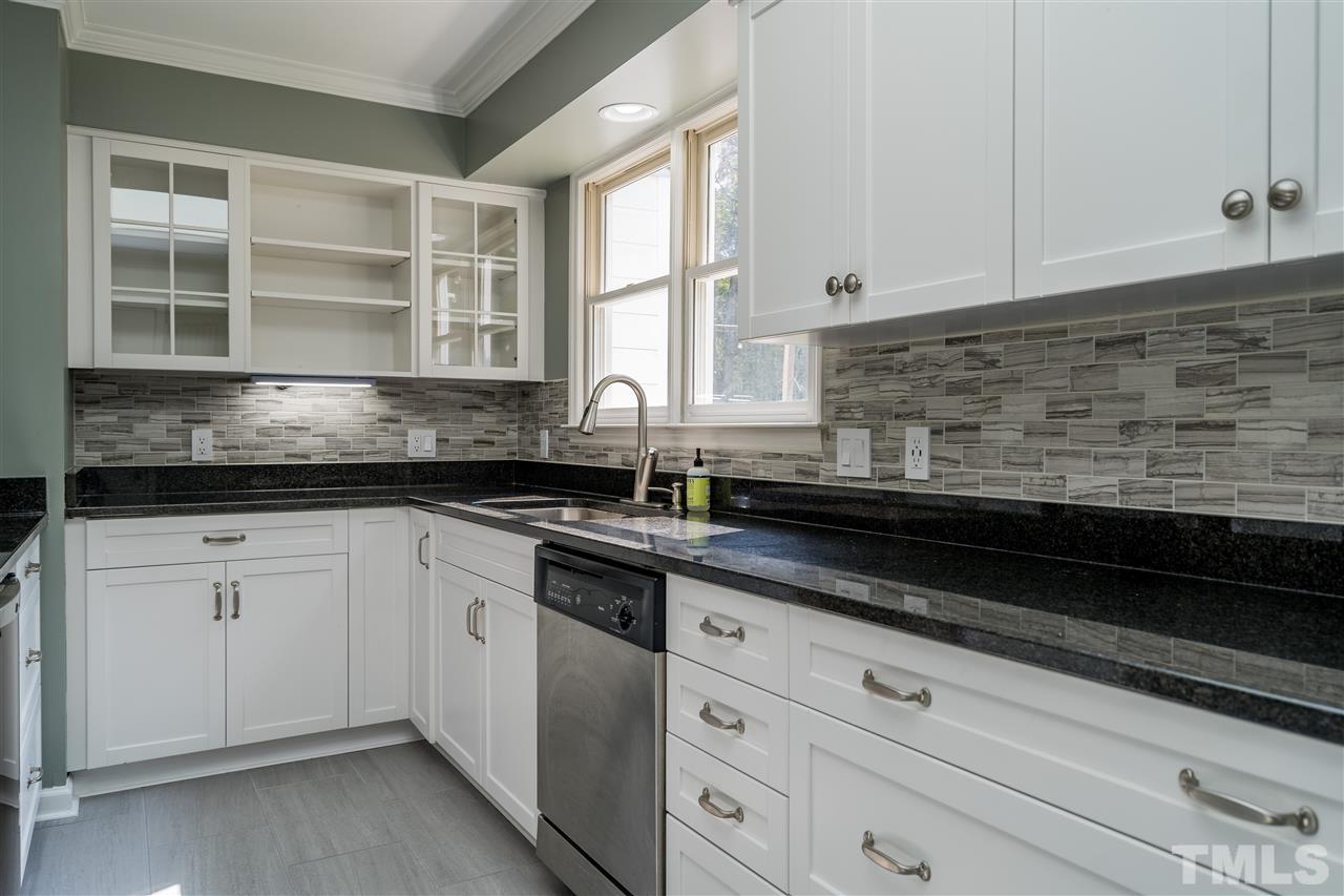 800 Hardimont Road Raleigh, NC 27609 - Photo 6 of 26 a kitchen with granite countertop white cabinets and black stainless steel appliances