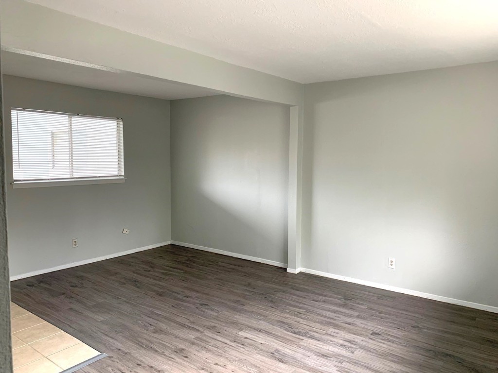 2609 East Cesar Chavez Street, Unit 204 Austin, TX 78702 - Photo 4 of 10 an empty room with wooden floor and windows