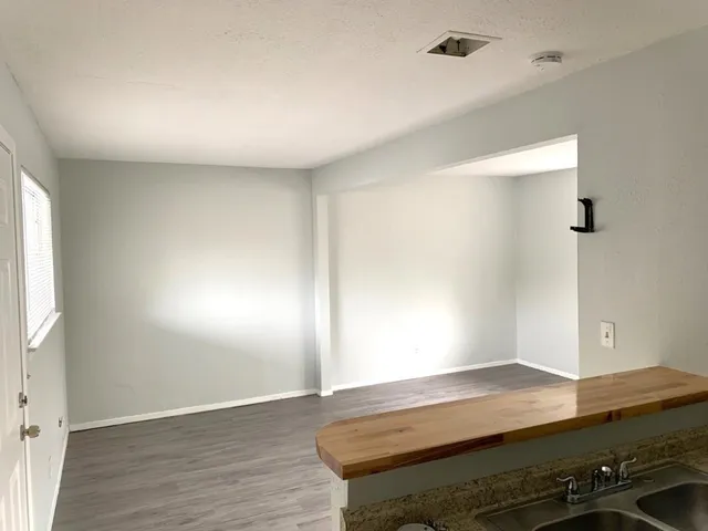 a view of room with wooden floor