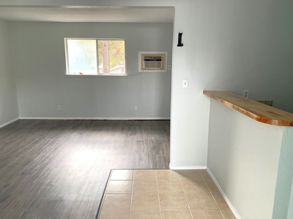 2609 East Cesar Chavez Street, Unit 204 Austin, TX 78702 - Photo 6 of 10 an empty room with wooden floor and windows