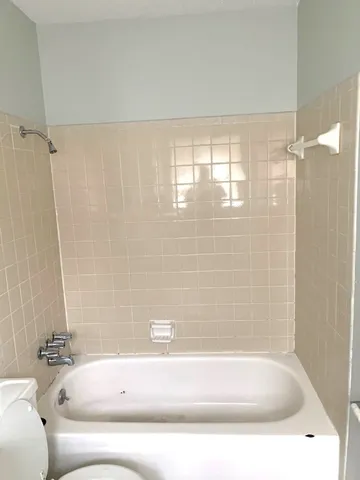 a bathroom with a bathtub and shower