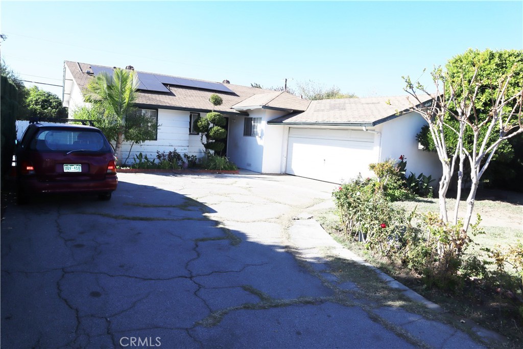 a front view of a house with a yard and a garage