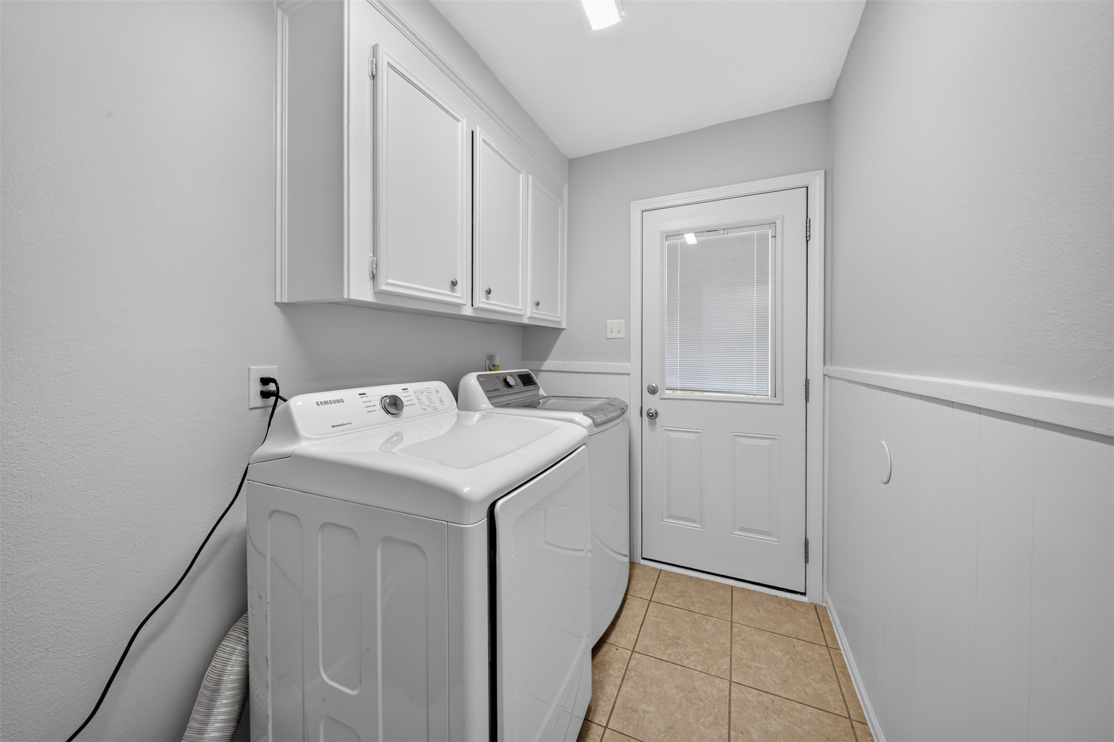 5211 Nodaway Lane Spring, TX 77379 - Photo 29 of 41 Utility Room - located just off Kitchen on first level. Door at center of photo leads into backyard.