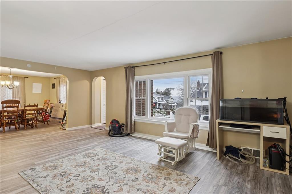 101 East Patterson Avenue Butler, PA 16001 - Photo 6 of 25 a living room with furniture a flat screen tv and a floor to ceiling window