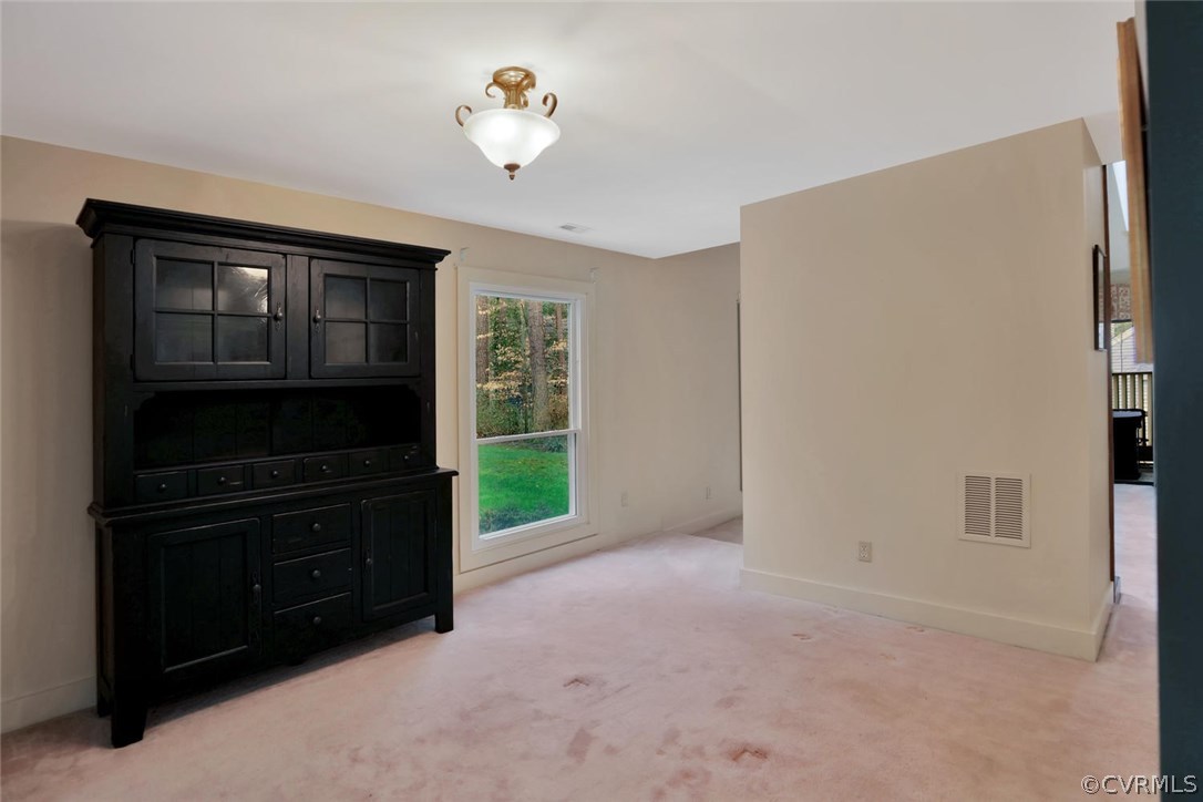 3907 Timber Ridge Place Midlothian, VA 23112 - Photo 9 of 32 a view of an empty room with a fireplace and a window