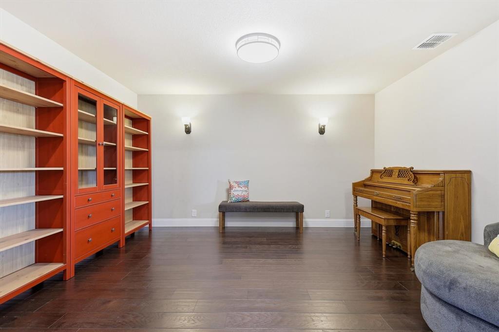 4609 Jasmine Trail Midlothian, TX 76065 - Photo 12 of 34 Living area with dark wood-type flooring and baseboards