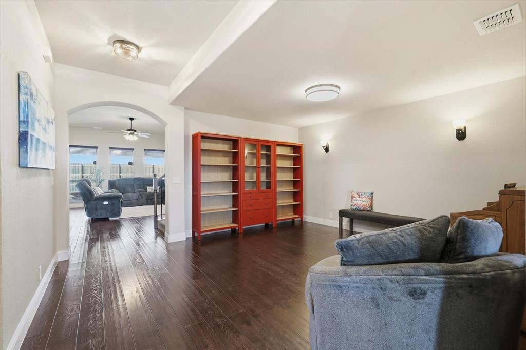 4609 Jasmine Trail Midlothian, TX 76065 - Photo 13 of 34 Living area featuring arched walkways, ceiling fan, and dark wood-style flooring