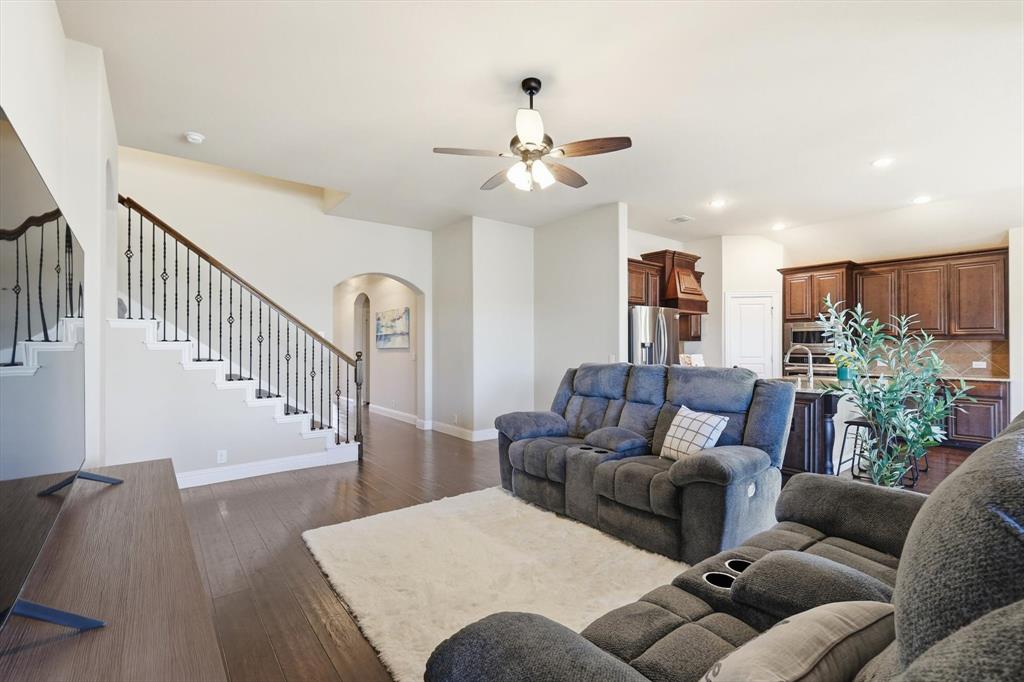 4609 Jasmine Trail Midlothian, TX 76065 - Photo 15 of 34 Living area with stairs, arched walkways, dark wood-type flooring, ceiling fan, and recessed lighting