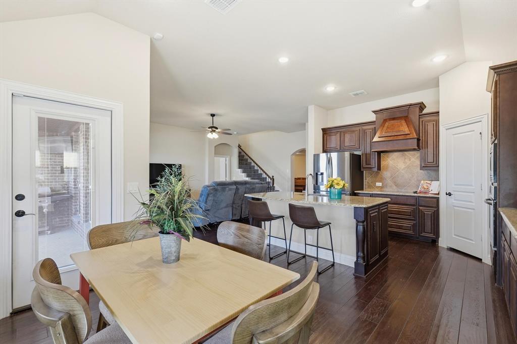 4609 Jasmine Trail Midlothian, TX 76065 - Photo 20 of 34 Dining area with stairs, ceiling fan, dark wood-style flooring, healthy amount of natural light, and vaulted ceiling