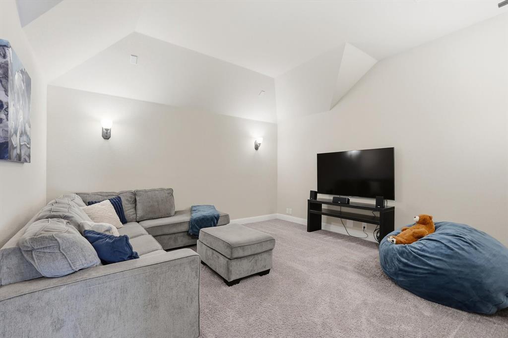 4609 Jasmine Trail Midlothian, TX 76065 - Photo 26 of 34 Media room featuring lofted ceiling and carpet