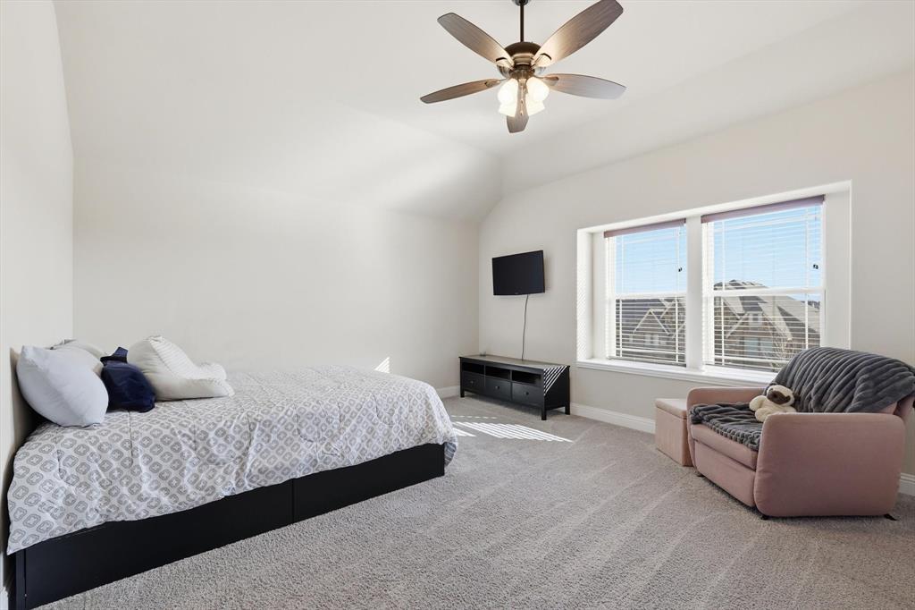 4609 Jasmine Trail Midlothian, TX 76065 - Photo 28 of 34 upstairs Carpeted bedroom featuring a ceiling fan and lofted ceiling