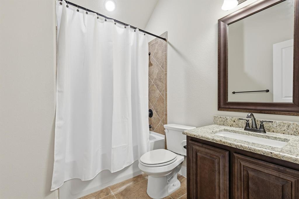 4609 Jasmine Trail Midlothian, TX 76065 - Photo 29 of 34 Full bathroom with shower / bathtub combination with curtain, vanity, and light tile patterned floors