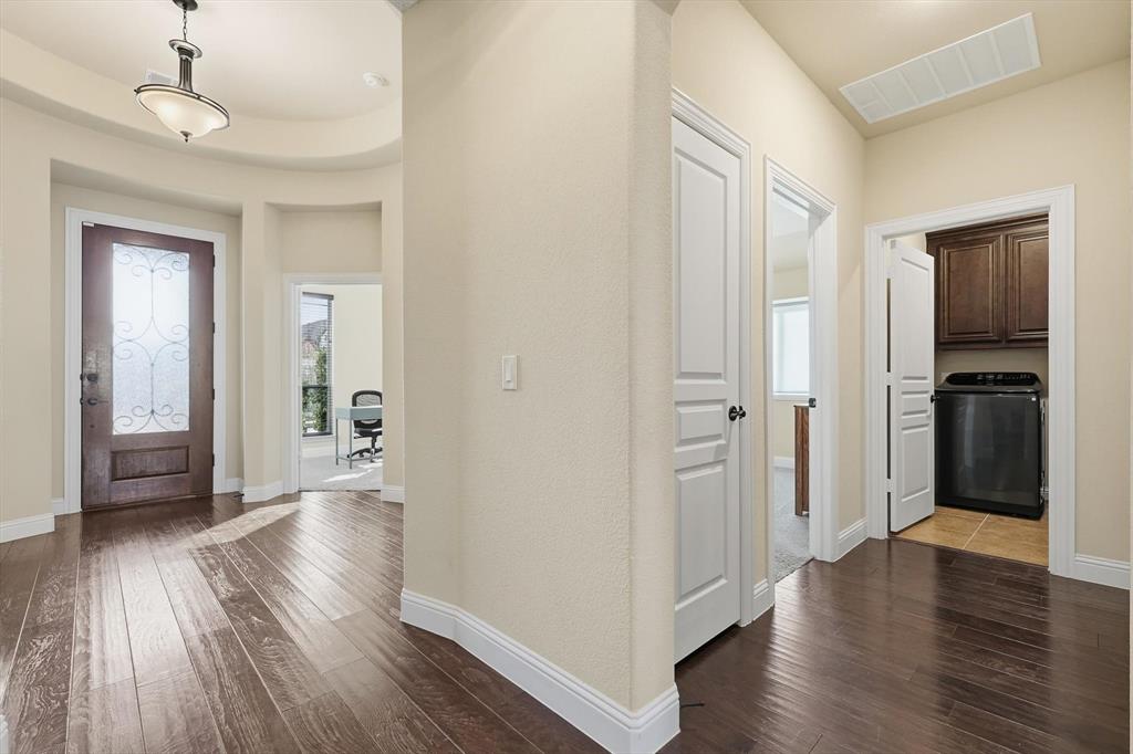 4609 Jasmine Trail Midlothian, TX 76065 - Photo 8 of 34 Entryway with washer / dryer, dark wood-type flooring, and healthy amount of natural light