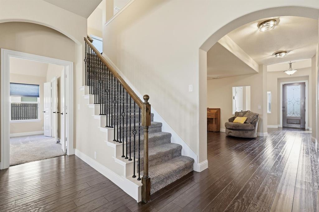 4609 Jasmine Trail Midlothian, TX 76065 - Photo 9 of 34 Entryway featuring arched walkways, dark wood-type flooring, and stairs