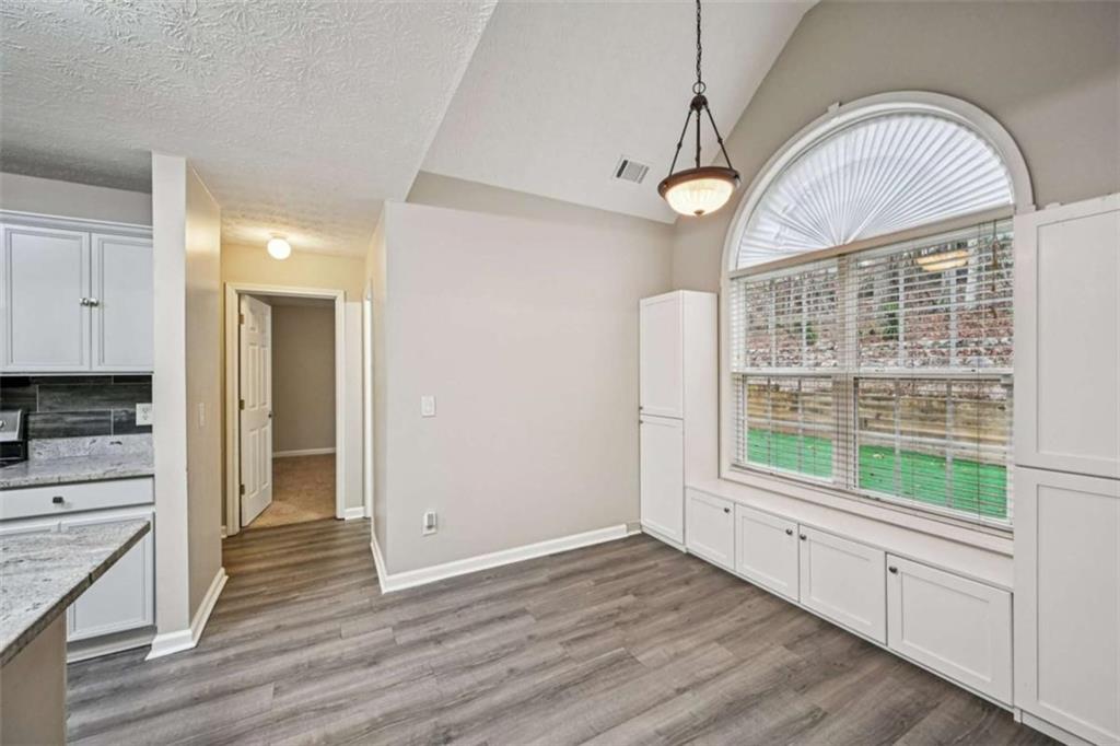 25 Castlehill Court Covington, GA 30016 - Photo 11 of 32 a view of an empty room with wooden floor and a window