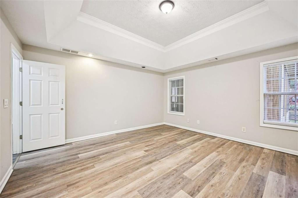 25 Castlehill Court Covington, GA 30016 - Photo 13 of 32 wooden floor in an empty room with a window