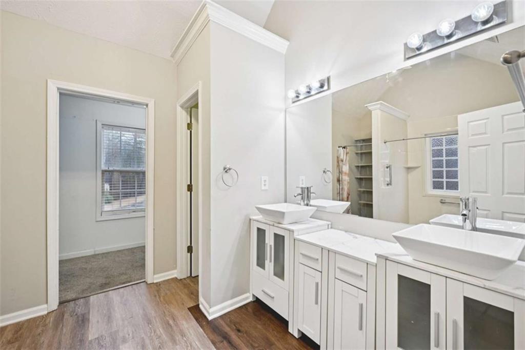 25 Castlehill Court Covington, GA 30016 - Photo 14 of 32 a spacious bathroom with a double vanity sink a mirror and a shower