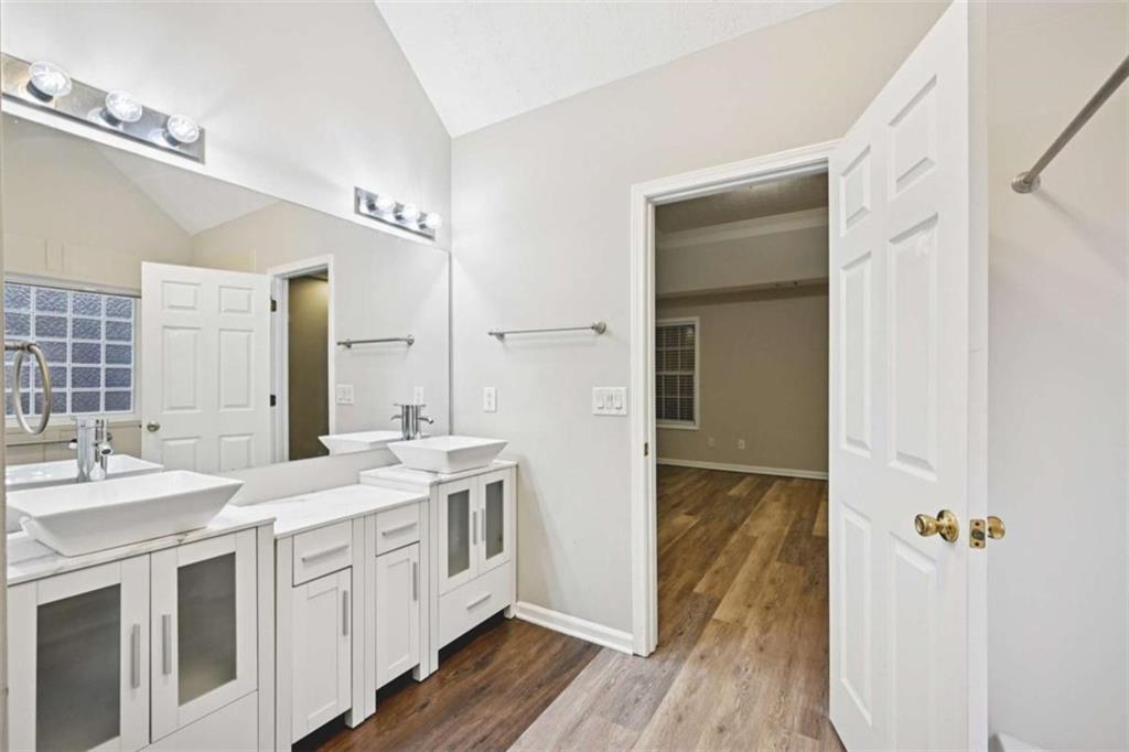 25 Castlehill Court Covington, GA 30016 - Photo 15 of 32 a spacious bathroom with a double vanity sink a mirror and a shower