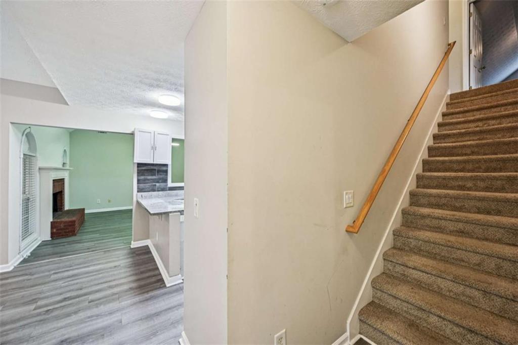 25 Castlehill Court Covington, GA 30016 - Photo 17 of 32 a view of a hallway with wooden floor and staircase