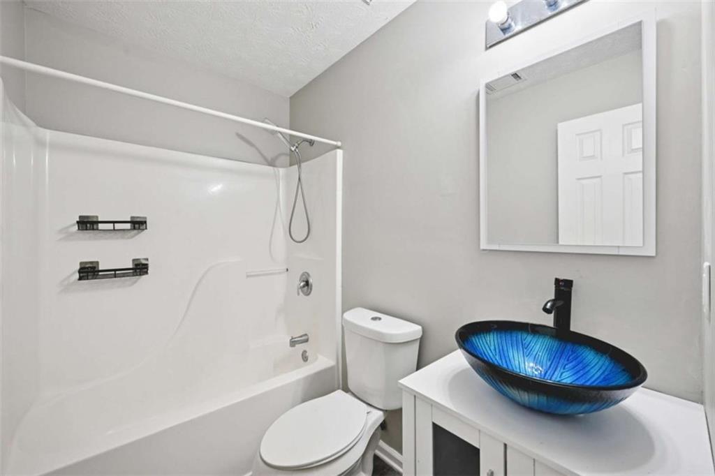 25 Castlehill Court Covington, GA 30016 - Photo 18 of 32 a bathroom with a toilet a sink and a shower