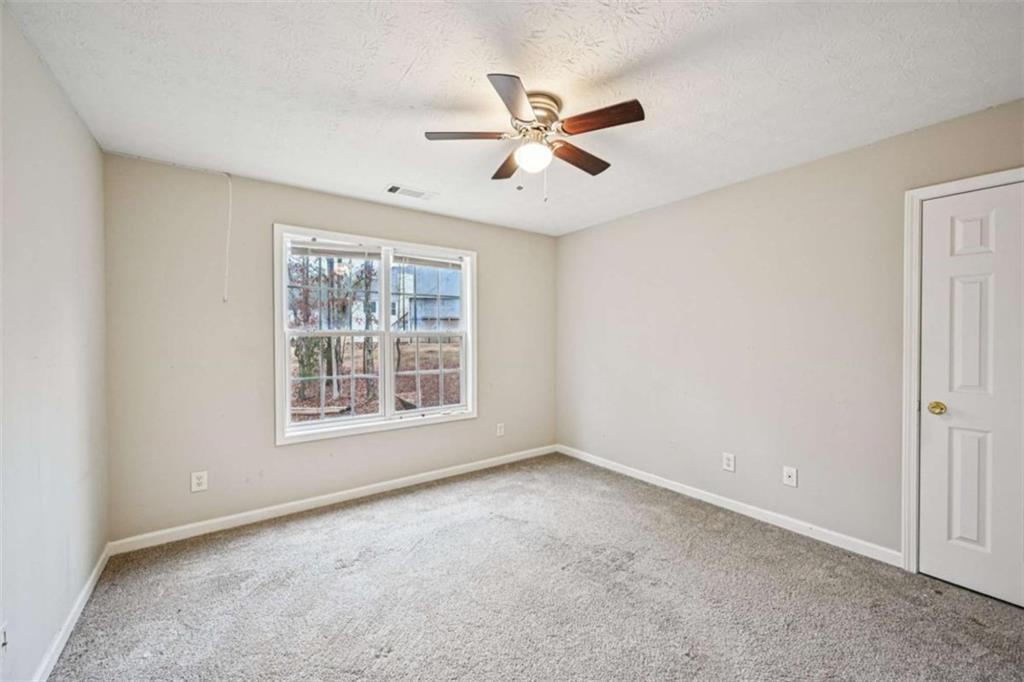 25 Castlehill Court Covington, GA 30016 - Photo 20 of 32 a view of an empty room with a window
