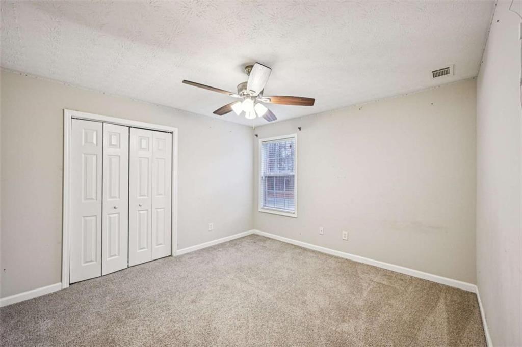 25 Castlehill Court Covington, GA 30016 - Photo 22 of 32 a view of an empty room with a window