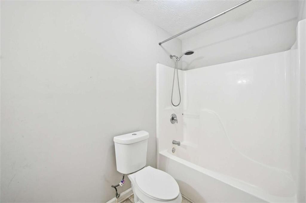 25 Castlehill Court Covington, GA 30016 - Photo 25 of 32 a white toilet sitting next to a bath tub