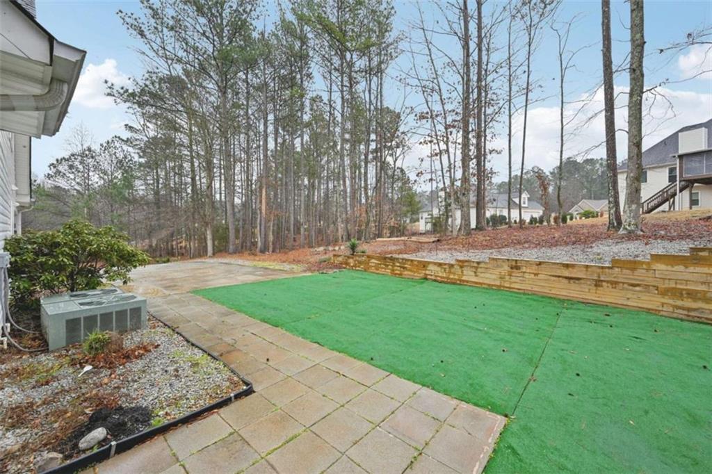 25 Castlehill Court Covington, GA 30016 - Photo 31 of 32 a view of a backyard with large trees