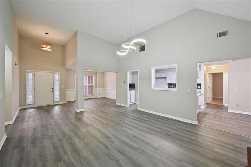 25 Castlehill Court Covington, GA 30016 - Photo 8 of 32 a view of an empty room with wooden floor and a ceiling fan