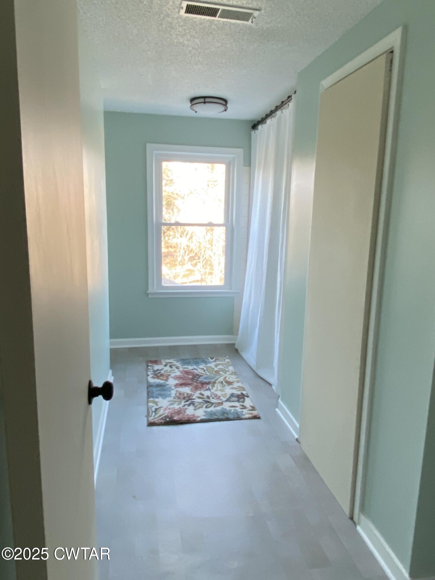 208 4th Street Henderson, TN 38340 - Photo 11 of 62 a view of an empty room with a window