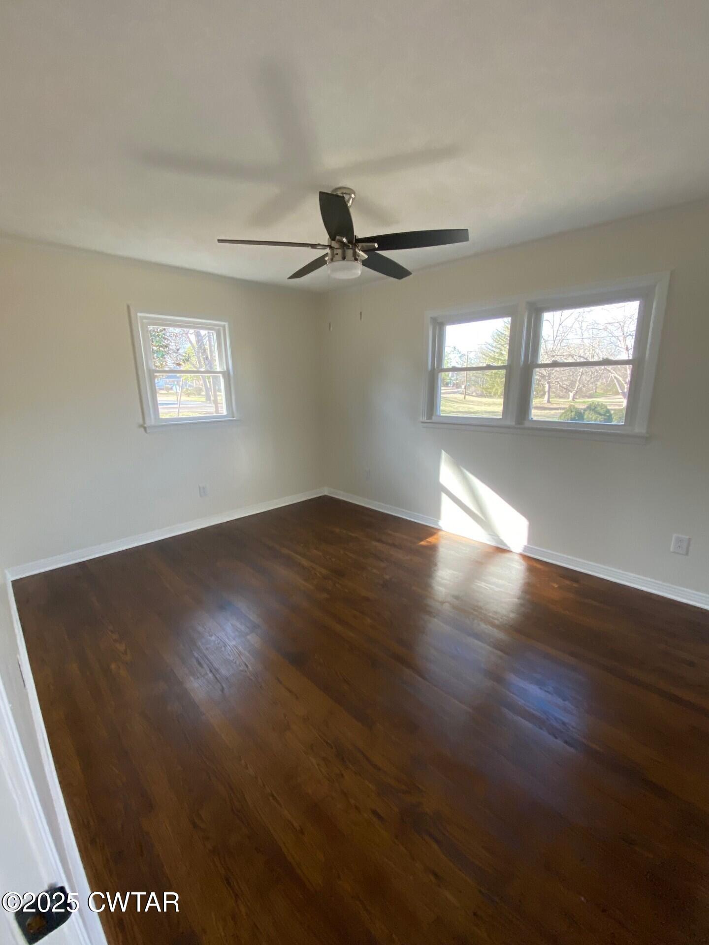 208 4th Street Henderson, TN 38340 - Photo 43 of 62 a view of an empty room with wooden floor and a window