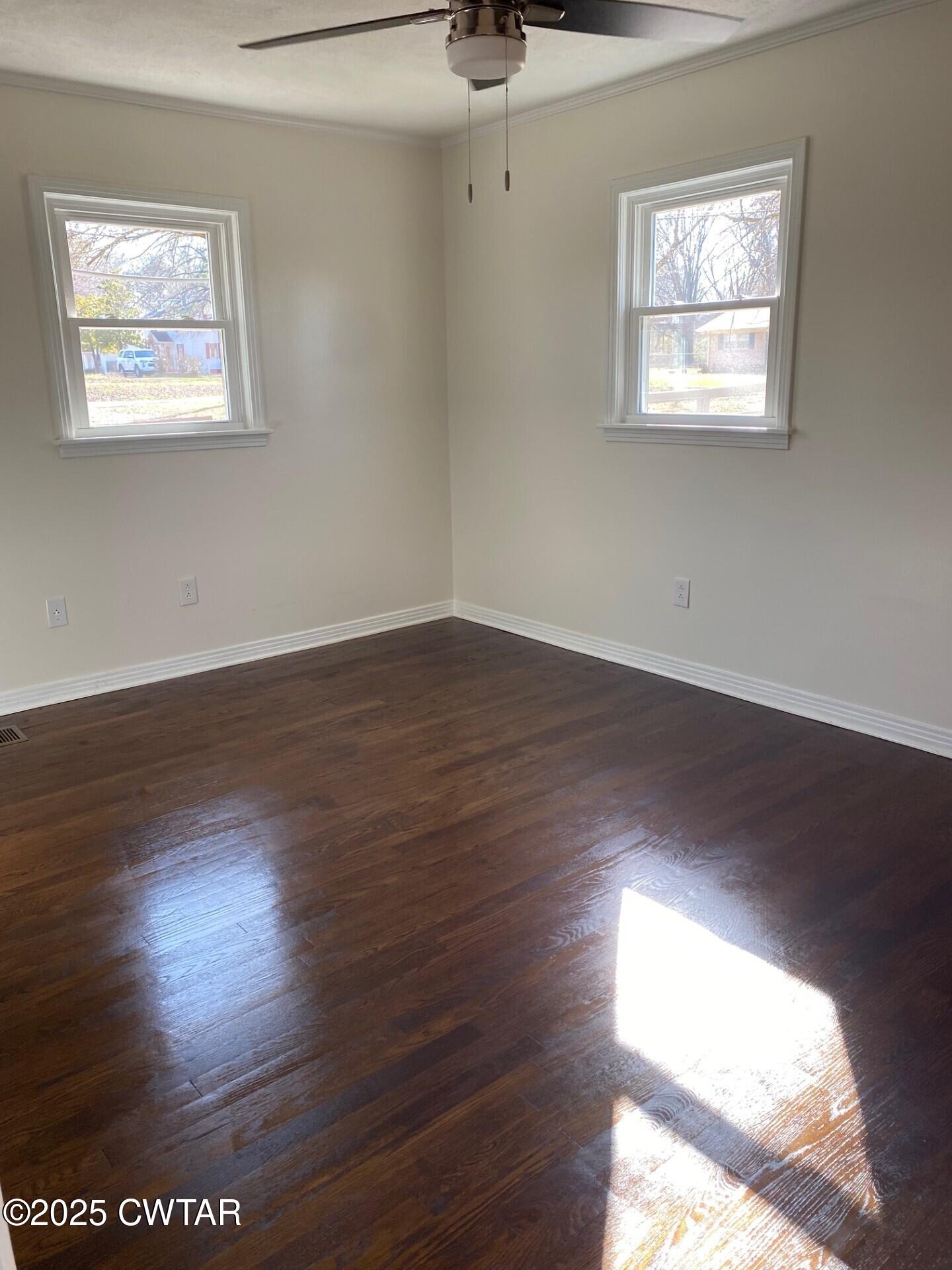 208 4th Street Henderson, TN 38340 - Photo 60 of 62 a view of an empty room with wooden floor and a window