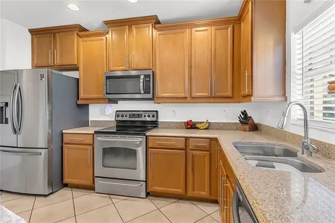 a kitchen with a sink stove and refrigerator
