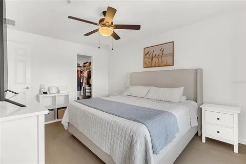 a bedroom with a large bed and a chandelier