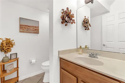 a bathroom with a sink vanity and toilet