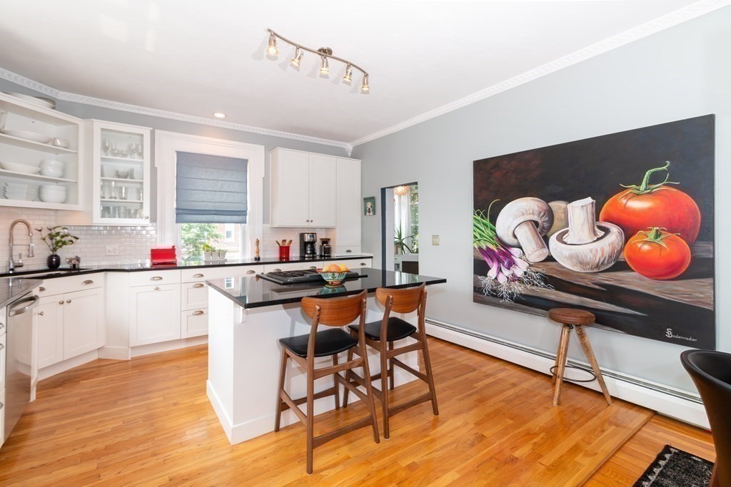 70 Cherry Street, Unit 1 Lynn, MA 01902 - Photo 16 of 40 a kitchen with stainless steel appliances kitchen island granite countertop a sink and a wooden floors