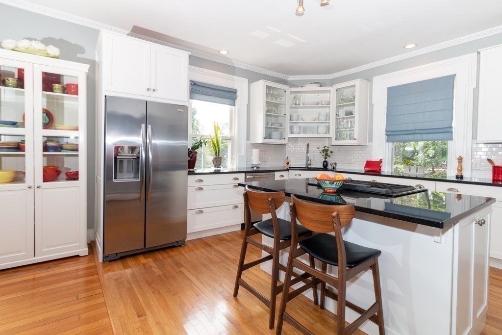70 Cherry Street, Unit 1 Lynn, MA 01902 - Photo 17 of 40 a kitchen with stainless steel appliances granite countertop a table chairs a stove a refrigerator and cabinets