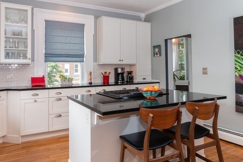 70 Cherry Street, Unit 1 Lynn, MA 01902 - Photo 18 of 40 a kitchen with stainless steel appliances granite countertop a stove a sink dishwasher and cabinets with wooden floor