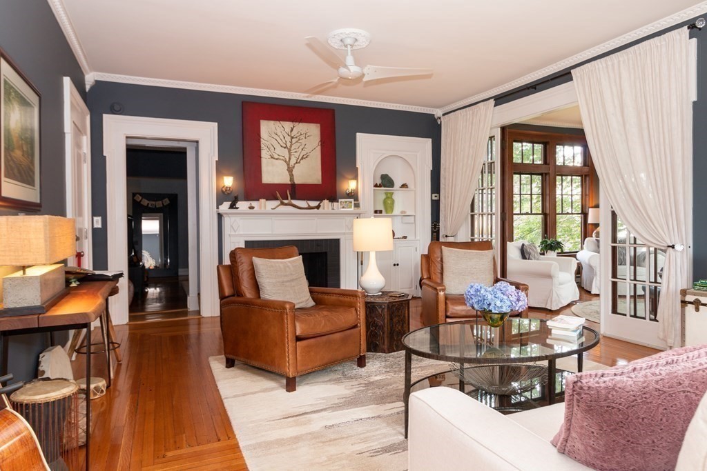 70 Cherry Street, Unit 1 Lynn, MA 01902 - Photo 3 of 40 a living room with furniture a fireplace and a chandelier