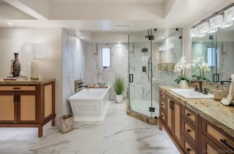a spacious bathroom with a double vanity sink mirror and shower