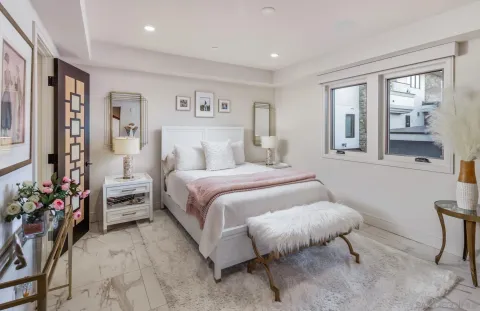 a spacious bedroom with a bed and a large window