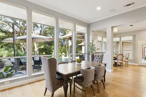 a view of a dining room with furniture large windows and wooden floor
